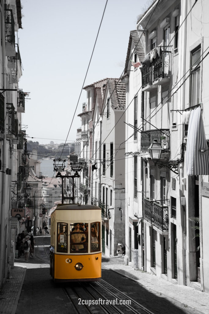 yellow lisbon tram where to see R. da Bica de Duarte Belo funicular barrio alto portugal